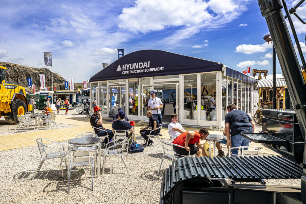 People sat outside a GL events branded temporary exhibition structure